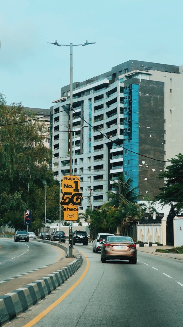 A city road lined with tall buildings